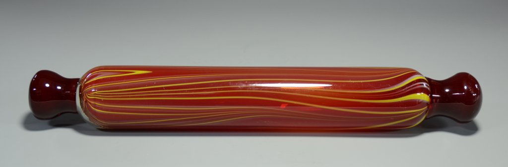 Glass Rolling Pin: Blown glass. Clear glass over red with yellow and white threads with applied red handles. 2.5"W., 16.5"L., circa 1980.