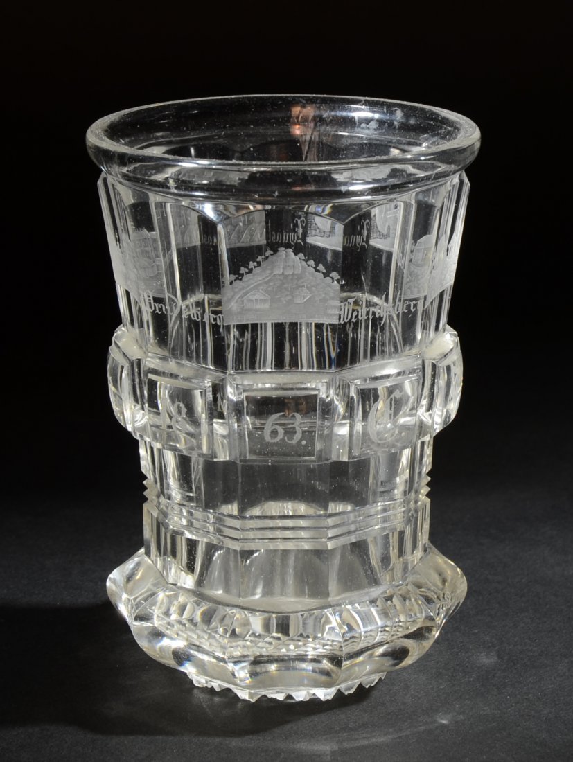 Beaker: Clear glass beaker with facet-cut body, diamond-cut base. Ten facets with engraved building scenes and town names. 4.6" ht., Bohemian, dated 1863.