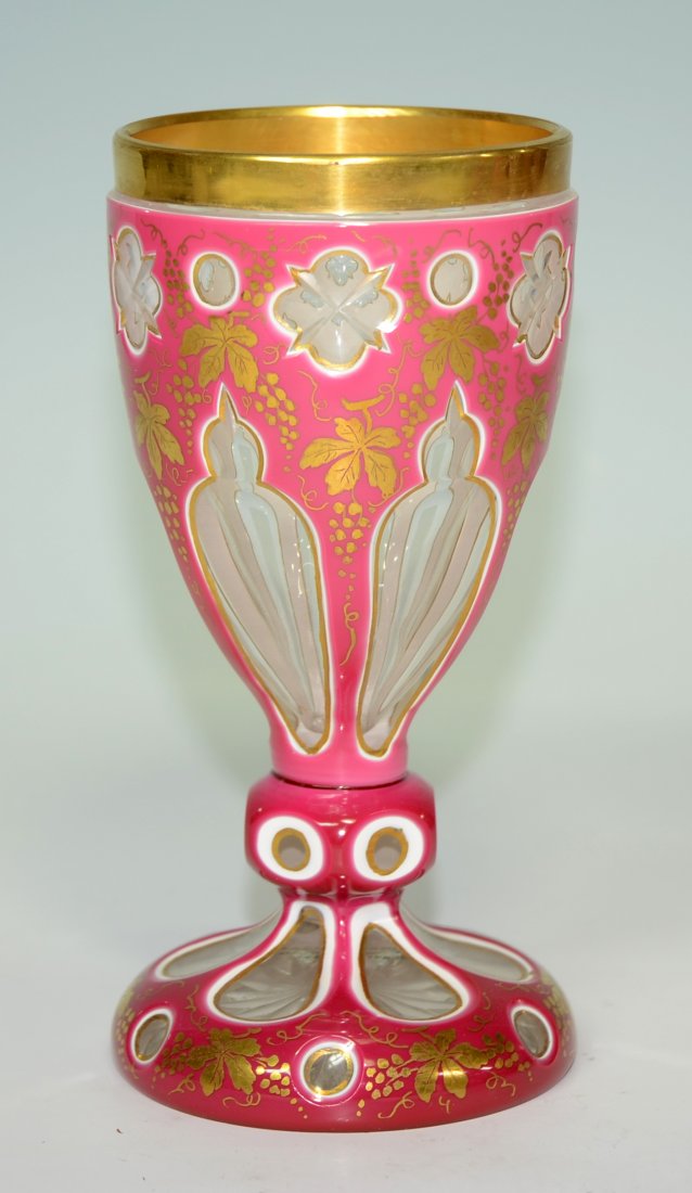 Double Overlay Beaker: Blown, pink over white over clear glass beaker with decorative facet-cuts to clear and a vine and leaf gild decoration. 6.0"ht., Bohemian, circa 1875.