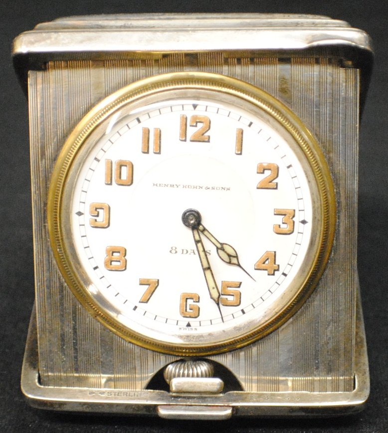 Henry Kohn and Son travel clock in sterling silver : Henry Kohn and Son travel clock in sterling silver case 3 ½”x 2 ½”, 200 gram total weight. Monogrammed S Movement works but we couldn’t wind the handles.