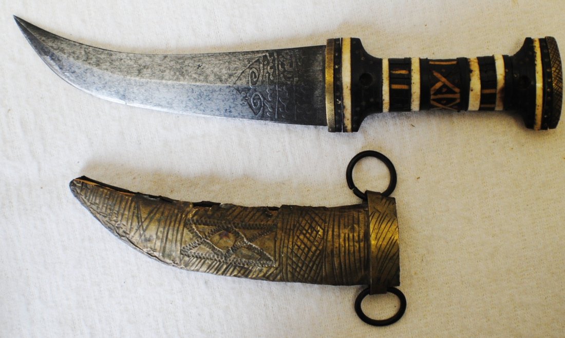 Islamic dagger with Arab engraving and ivory inlaid han: Islamic dagger with Arab engraving and ivory inlaid handle. 10” with sheath.
