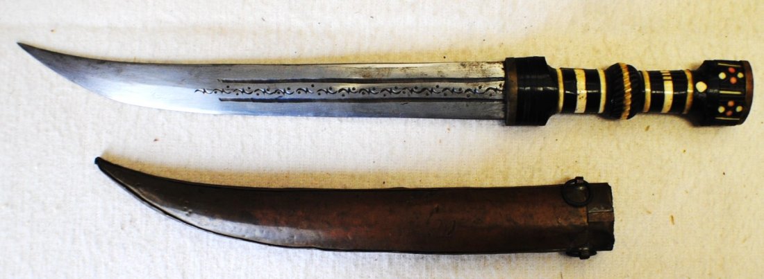 Islamic dagger with incrusted handle: Islamic dagger 17” with the sheath, blade 11 ¼”. The hndle is incrusted with ivory, mother of pearl, etc. Engraved blade.