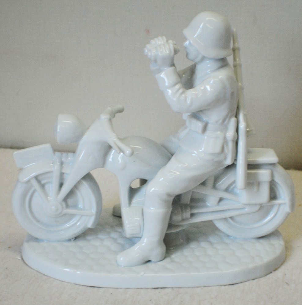 ALLACH German porcelain figurine of Nazi Motorcyclist: ALLACH German porcelain figurine of Nazi Motorcyclist 9” tall, 10” x 5” base. Porcelain figurines with ALLACH marking were manufactured in Nazi Germany in 1936 – 1945, some figurines made in a