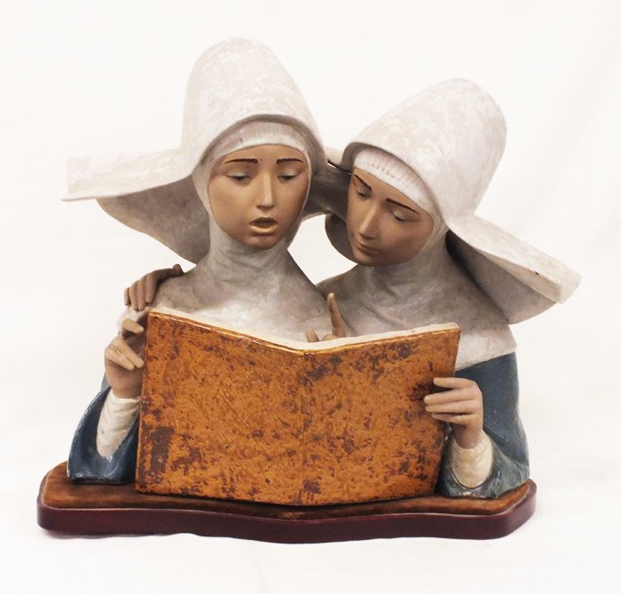 Lladro "Singing Nuns" sculpture: Lladro "Singing Nuns" sculpture. 15" tall, 18" wide, 12 1/2" deep, weight 25.5 lb with wooden stand. Marked on the bottom. Issued 1978, retired 1981, Gres finish. Sculptor Francisco Catalá