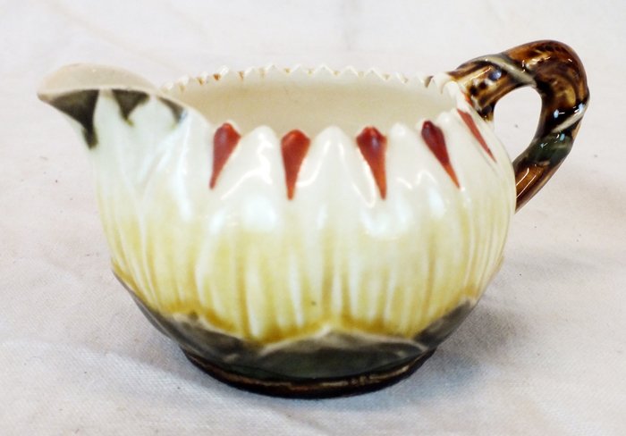 ZSOLNAY PECS Hungary creamer: ZSOLNAY PECS Hungary creamer 2 1/2" tall, 4 3/4" wide, weight 3 oz. Marked on the bottom, old antique store label. Circa 1800's.
