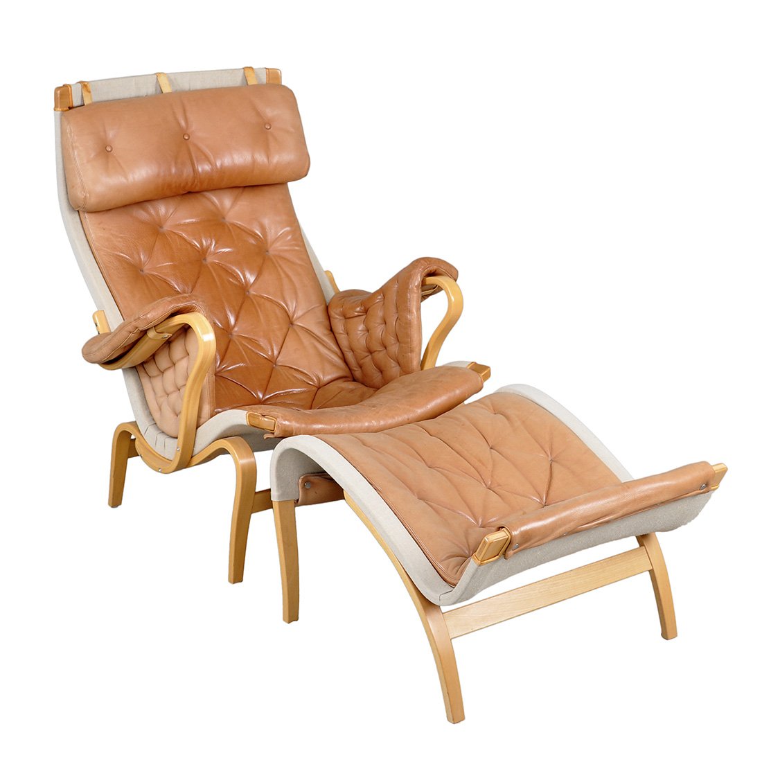 FÅTÖLJ MED FOTPALL, "Pernilla", BRUNO MATHSSON: Ergonomisk svängd form. Böjträ av bok. Tillhörande fotpall. Klädd i brunt läder på canvas. Bruksslitage, fläckar.