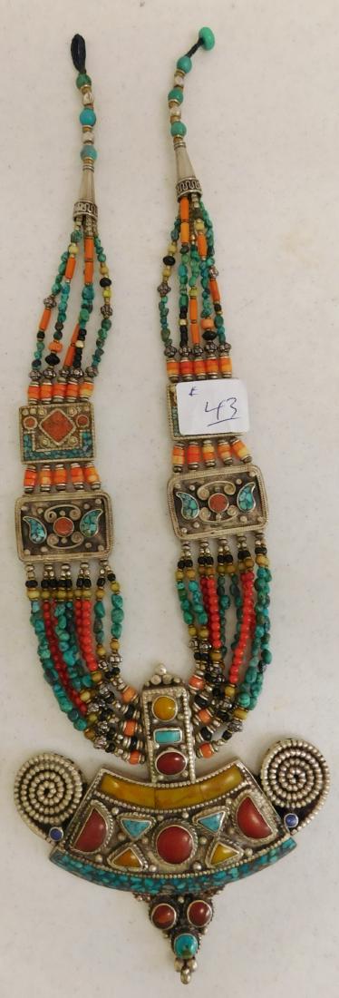 Moroccan Jeweled Necklace: Moroccan Jeweled Necklace, circa 1960s. Made of silver, carnelian, turquoise, glass and coral, the item is 10.25" as worn. From North Africa. Very ethnic and colorful. Pendant measures 4.25" x 4" x 0.