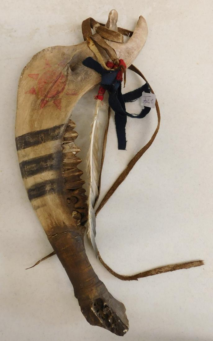 Plains Indian Jawbone Club: Plains Indian Jawbone Club, 20th century item. Made of paint, bone, leather, feather and cloth, the item is 8.5" x 16" x 1.5". Colorado. Probably a horse jaw. Condition: Good, see images. Shipping: $2