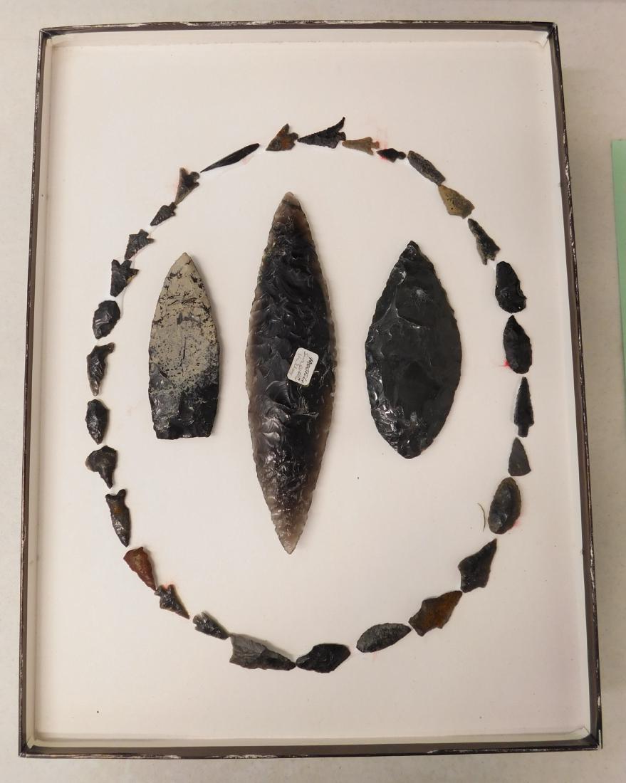 Obsidian Collection: Obsidian Collection, pre-historic items. Made of obsidian, the main point measures 8" x 2" and the others are from 0.5" to 5.25" long. Modoc County, California. Frame not included. Condition: As found