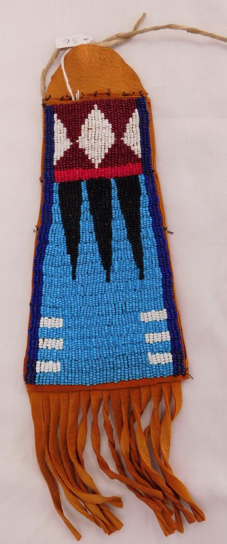 Plains Indian Bag w/Beadwork: Plains Indian Bag w/Beadwork, modern item. Made of leather and glass beads, the bag measures 4.25" x 13" w/fringe. Dakotas. Condition: Good, see images. Shipping: $12.50 w/insurance and signature.