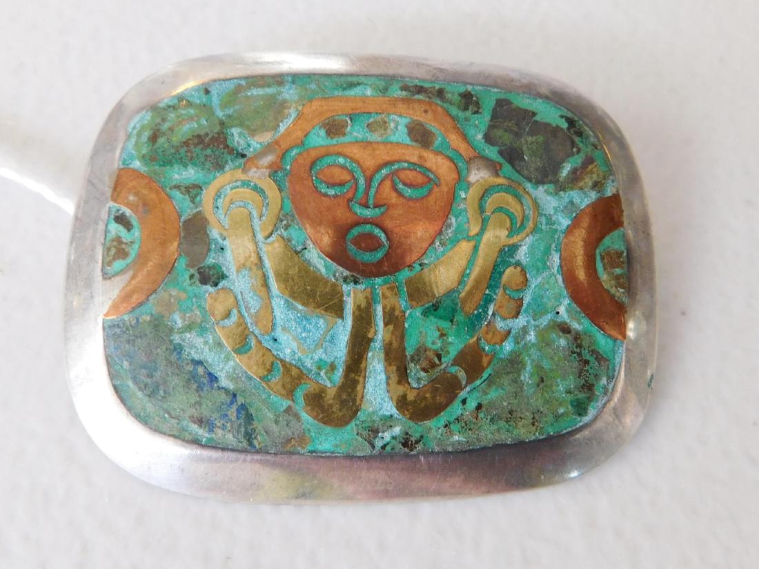 Antique Mixed Metal Pin or Pendant: Antique Mixed Metal Pin or Pendant, circa 1940s-50s. Made of brass, copper, stone chip inlay and sterling silver, the item measures 2" x 1.5". Metales Casados, Mexico. Pre-Columbian-style motif on pin