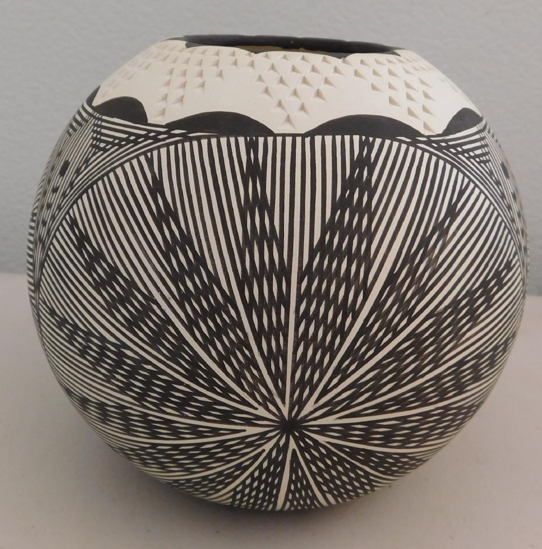 Acoma Pot: Acoma Pot, c. 1970s. Made of clay and paint, the item measures 5" x 5". Signed JO. Acoma, New Mexico. Carved pot with painted lines, fantastic design. Condition: Good, see images. Shipping: $24.50 w/i