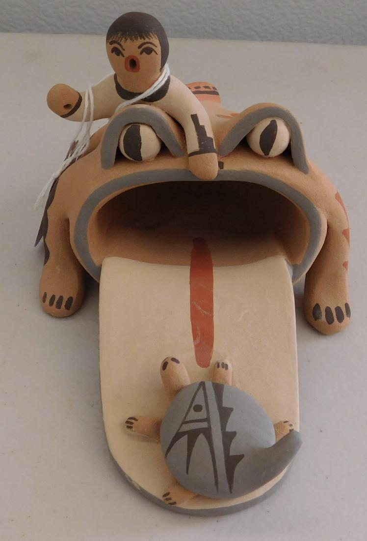 Jemez Pottery Frog Figure: Jemez Pottery Frog Figure, c. 1970s. Made of clay and paint, the item measures 5.75" x 4" x 3.5". Jemez Pueblo, Phillip M. Fragua. Frog figure with turtle entering mouth at base of tongue and small ch