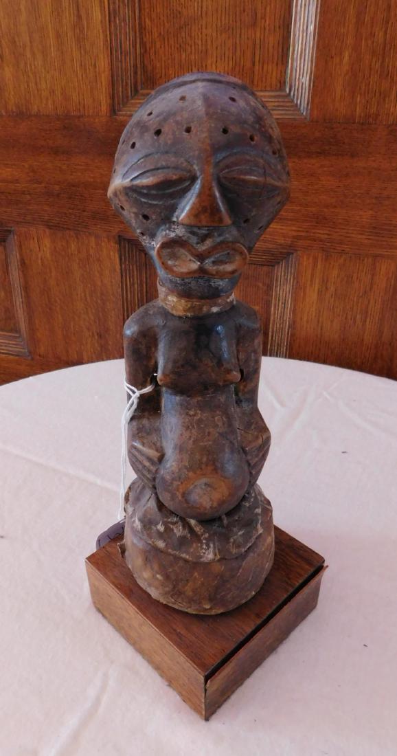 African Songye Power Fetish Figure: African Songye Power Fetish Figure, late 19th century. Made of rawhide, wood and wood stand, the item measures 3" x 3" x 9.25", stand measuring 3.75" x 3.75" x 1.5". Songye, Congo. Drilled holes in fa