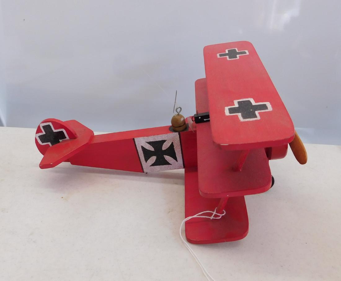 WWI German Fokker Toy Plane: WWI German Fokker Toy Plane, 20th century item. Made of wood, metal and plastic wheels, the item measures 12" x 9" x 5.5". American. Nice old triplane model. Condition: Good, dusty, see images. Shippi