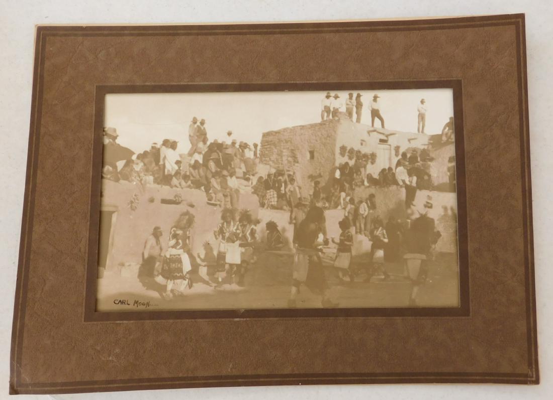 Signed Carl Moon Photograph: Signed Carl Moon Photograph, c. 1907. Made of paper and ink, the frame measures 10 7/8" x 14 7/8". Carl Moon, signed by artist. Nice framed Sepia tone photograph of a pueblo ceremony. Condition: Good,