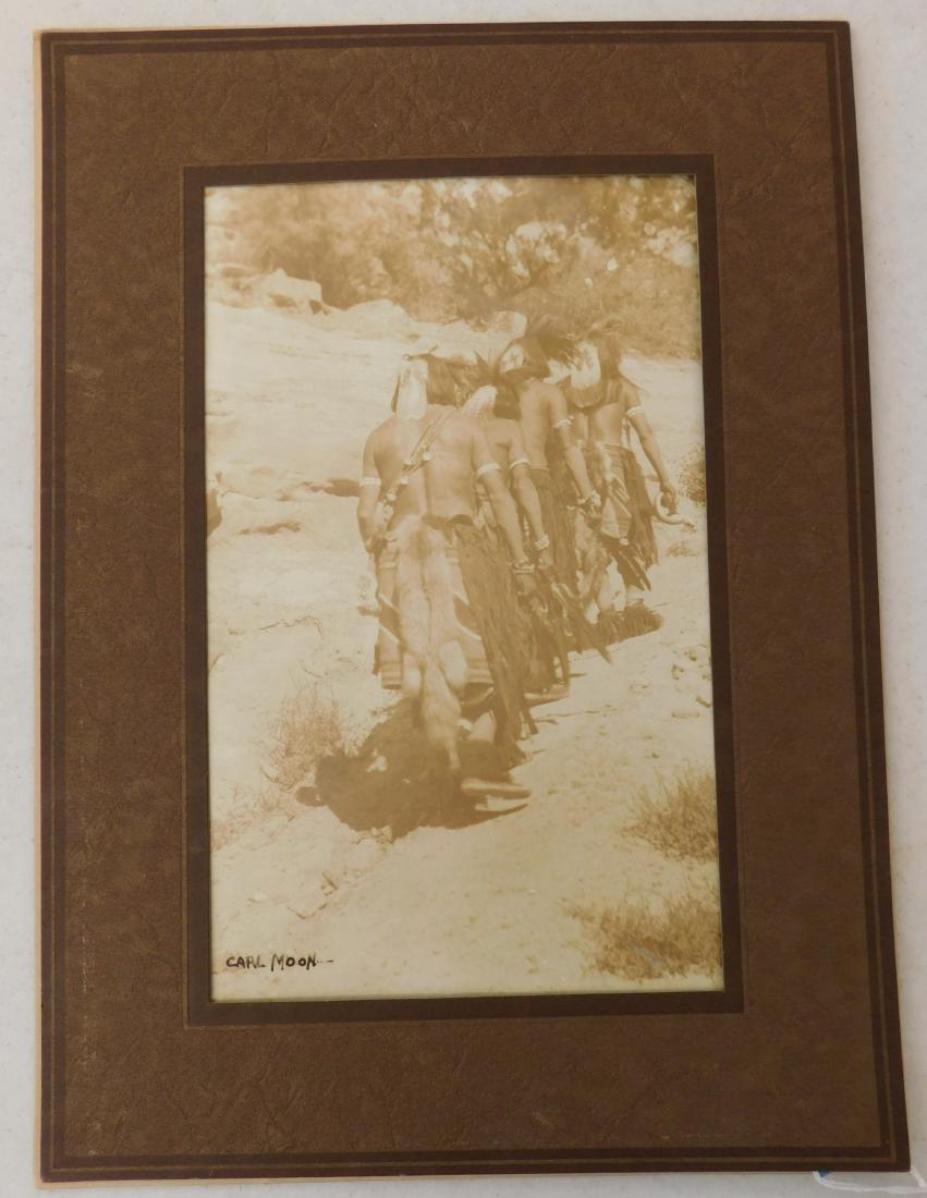 Signed Carl Moon Photograph: Signed Carl Moon Photograph, c. 1907. Made of paper and ink, the frame measures 10 7/8" x 14 7/8". Carl Moon, signed by artist. Nice framed Sepia tone photograph of tribal men on the hunt. Condition: