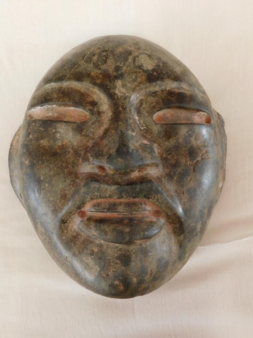Olmec Green Mask: Olmec Green Mask, pre-Columbian item. Made of jadeite, the item measures 6 1/2" x 6 1/4" x 2 1/2". Veracruz, Mexico. Helm COA available. From an old, 1960s California collection. Condition: Old damage