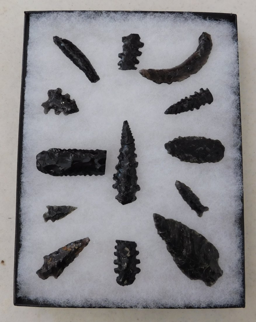 California Obsidian Collection: California Obsidian Collection, pre-historic items. Made of obsidian, the longest measures 2 1/2". Stockton, California. Nice crescent, many serrated pieces. Frame not included. Condition: As found, s