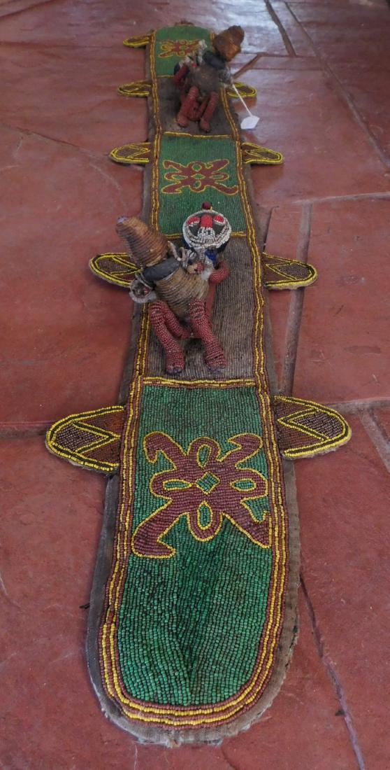Nigerian Beadwork Belt: Nigerian Beadwork Belt, c. 1940s. Made of glass and cloth, the item measures 55" x 11". Nigeria. Beaded belt, woman and child. Condition: Minor bead loss, see images. Shipping: $26.50 w/insurance and