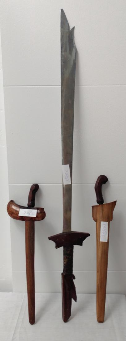 Indonesian Weapons Cache: Indonesian Weapons Cache, c. 1900s. Made of wood, steel and brass, the items measure 40" x 6", 19" x 3" and 20" x 6". Indonesia. Small ones have meteorite metal blade. Condition: Worn, see images. Shi