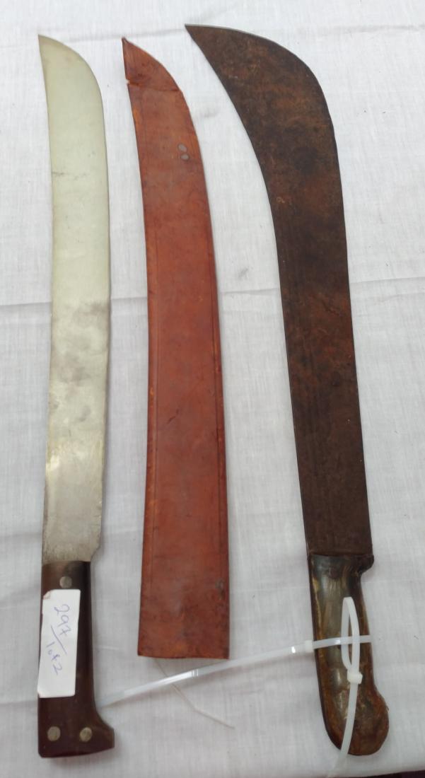 Pair of Large Machetes: Pair of Large Machetes, c. 1940s. Made of steel, leather, horn and plastic, the items measure 27" x 5". Probably English and Spanish. Condition: Worn, some rust, see images. Shipping: $32.50 w/insuran