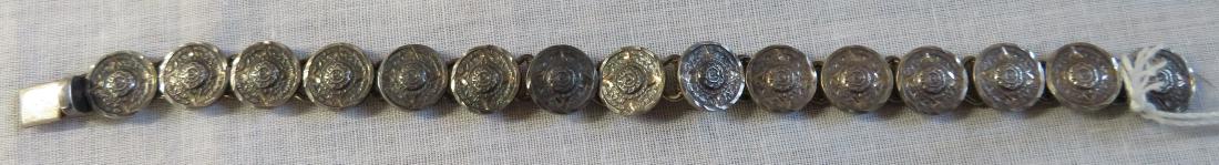 Antique Mexican Link Bracelet: Antique Mexican Link Bracelet, c. 1940s. Made of sterling silver, the item measures 7 1/2" x 1 1/4". .925, Mexico, T8-16. Weighs approx. 26.8 grams. Aztec calender design on coin-like link pieces. Con