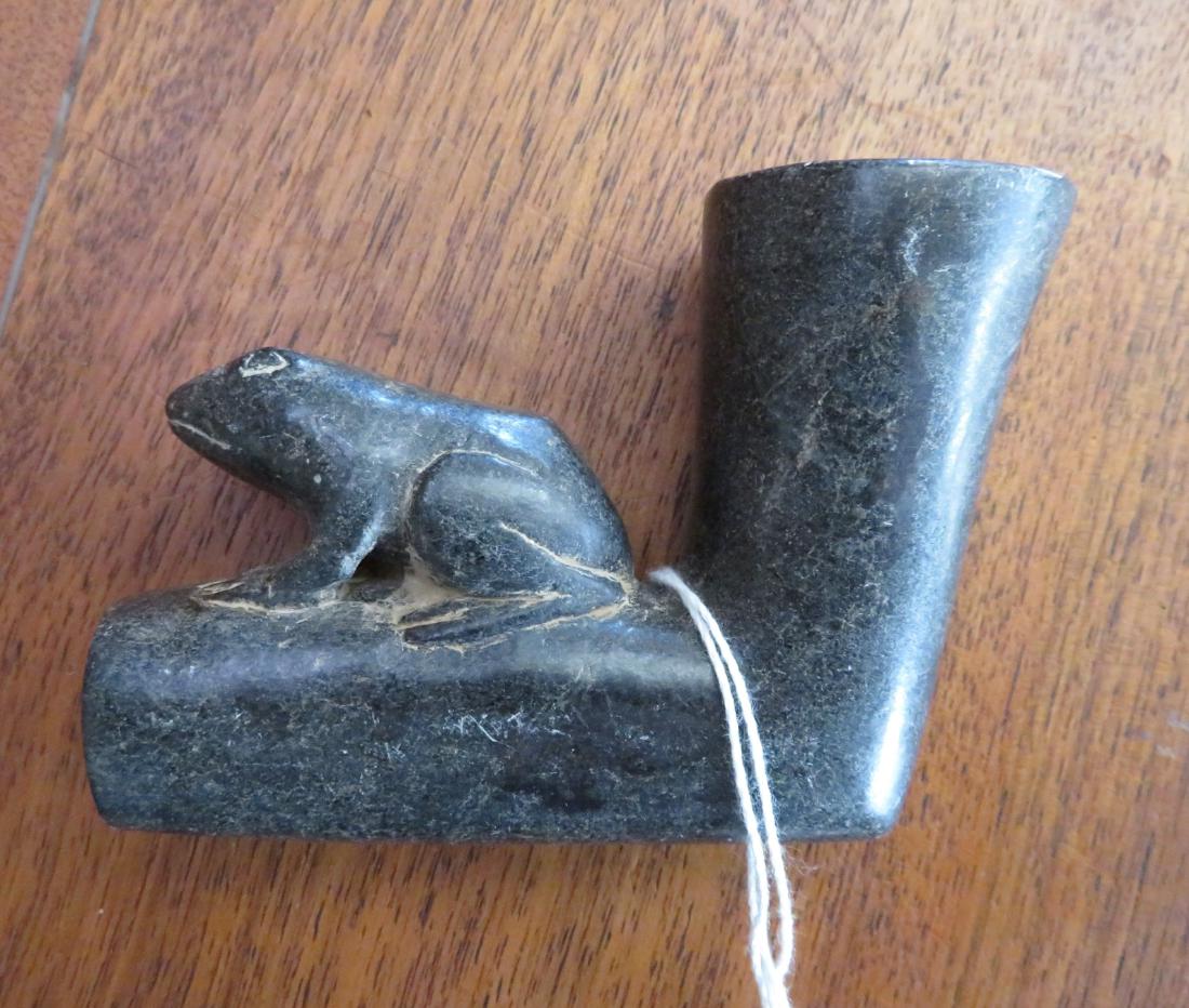 Frog Effigy Elbow Pipe: Frog Effigy Elbow Pipe, pre-historic item. Made of steatite, the item measures 3 3/4" x 2 1/2" x 1 1/2". North Carolina. Condition: As found, see images. Shipping: $18.50 w/insurance and signature.