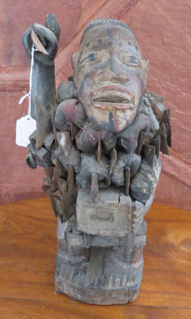 African Fetish Figure w/Spear: African Fetish Figure w/Spear, early 20th century item. Made of wood, iron and fabric, the item measures 15" tall. Congo. Many medicine bundles. Condition: Good, see images. Shipping: $32.00 USA estim