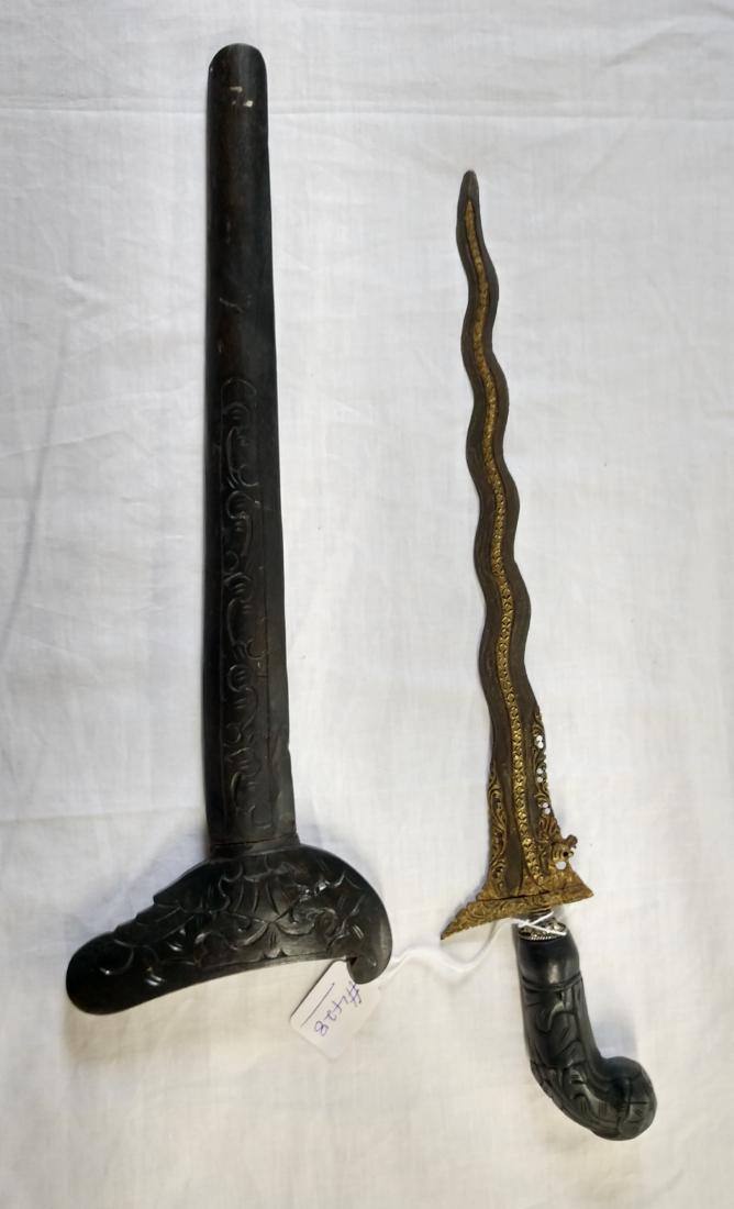 Gold Inlaid Indonesian Kris Knife: Gold Inlaid Indonesian Kris Knife, c. 1940s. Made of wood, iron and gold, the item measures 20" x 4". Indonesia. Fancy inlay on meteorite-sourced blade. Condition: Good, see images. Shipping: $28.00 w