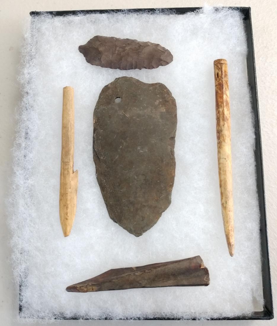 Ancient Eskimo Artifacts: Ancient Eskimo Artifacts, pre-historic items. Made of flint, slate and bone, the items measure 5" and shorter. Point Barrow, Alaska. Fine engraved needle with eye is 5" long. Frame not included. Condi