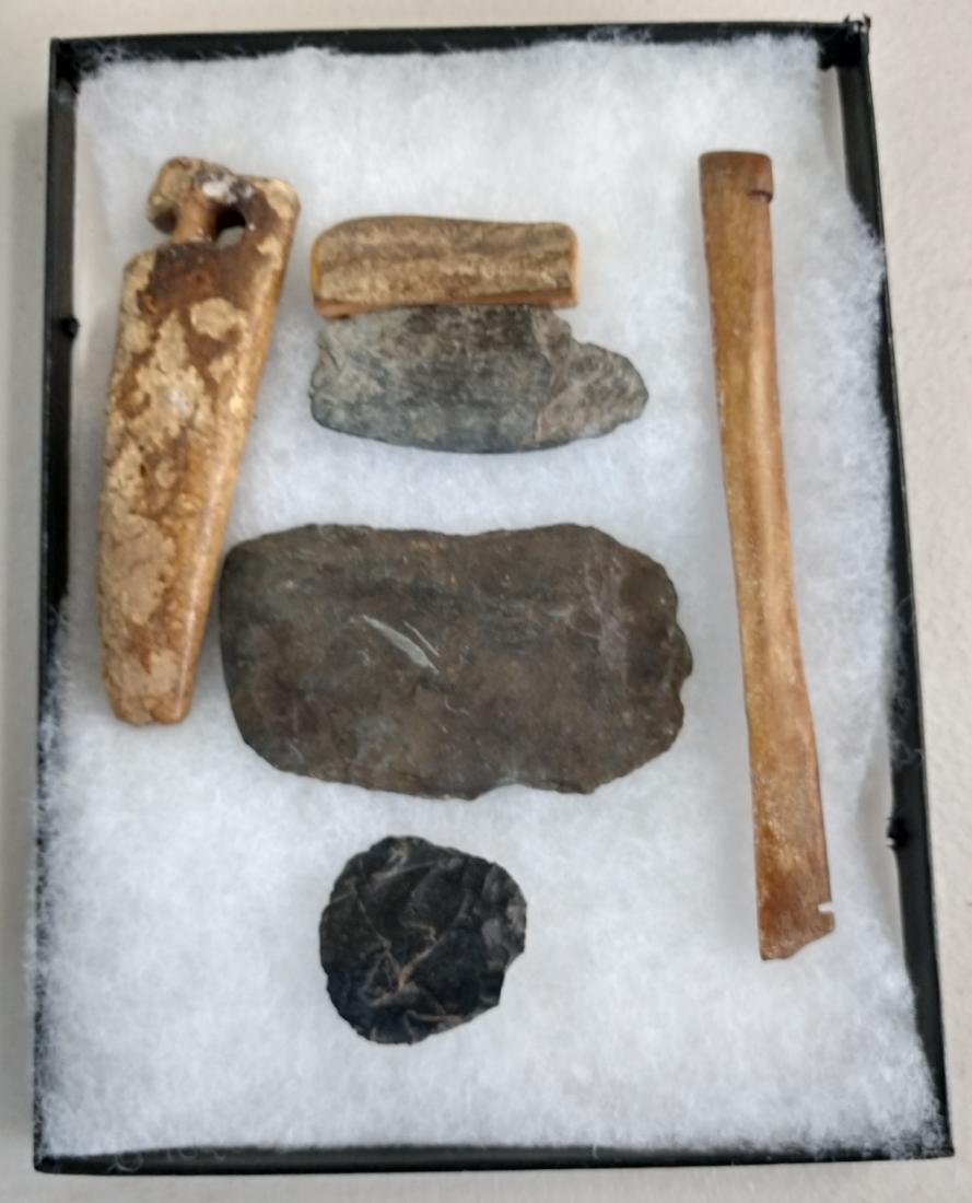 Ancient Eskimo Artifacts: Ancient Eskimo Artifacts, pre-historic items. Made of flint, slate and bone, the items measure 5 3/4" and shorter. Point Barrow, Alaska. Including ulu knife. Frame not included. Condition: As found, s