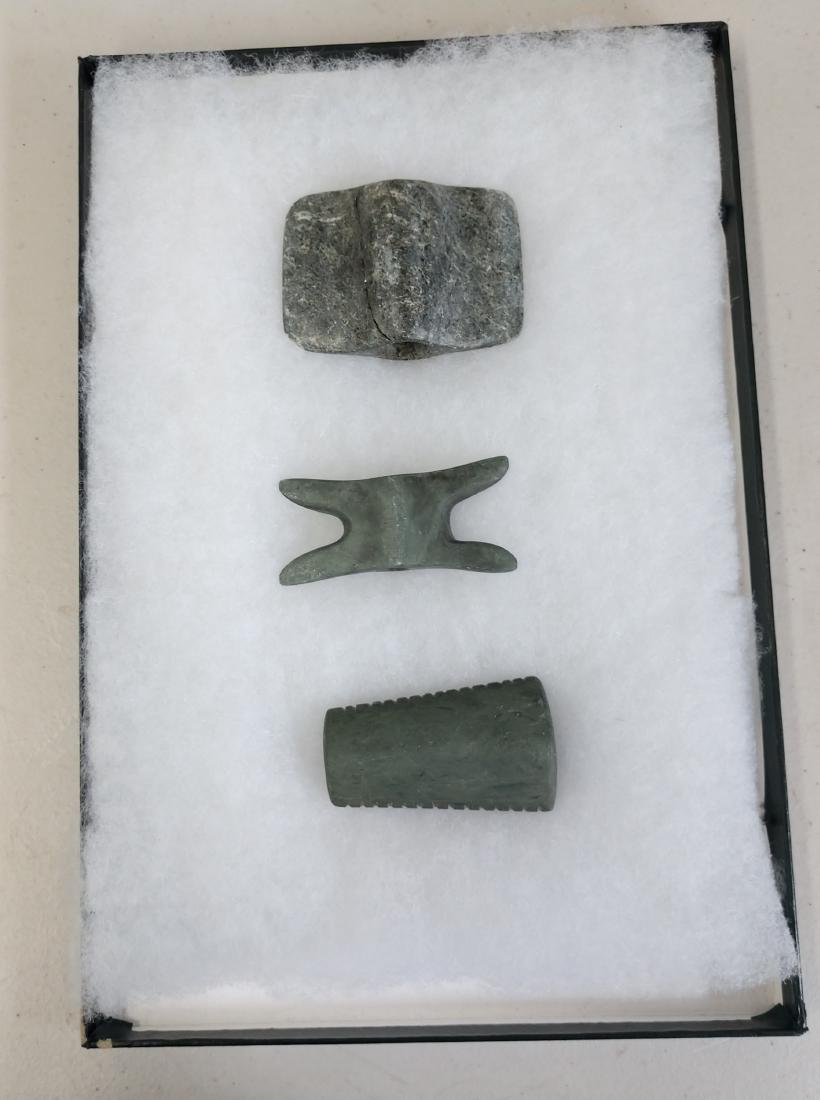 3 Ohio Bannerstones: 3 Ohio Bannerstones, Hopewell era. Made of steatite and banded slate, the largest item measures 3 1/2" x 2 1/2". Ohio. One is a reel bannerstone, one may be a tube pipe. Condition: As found, see image