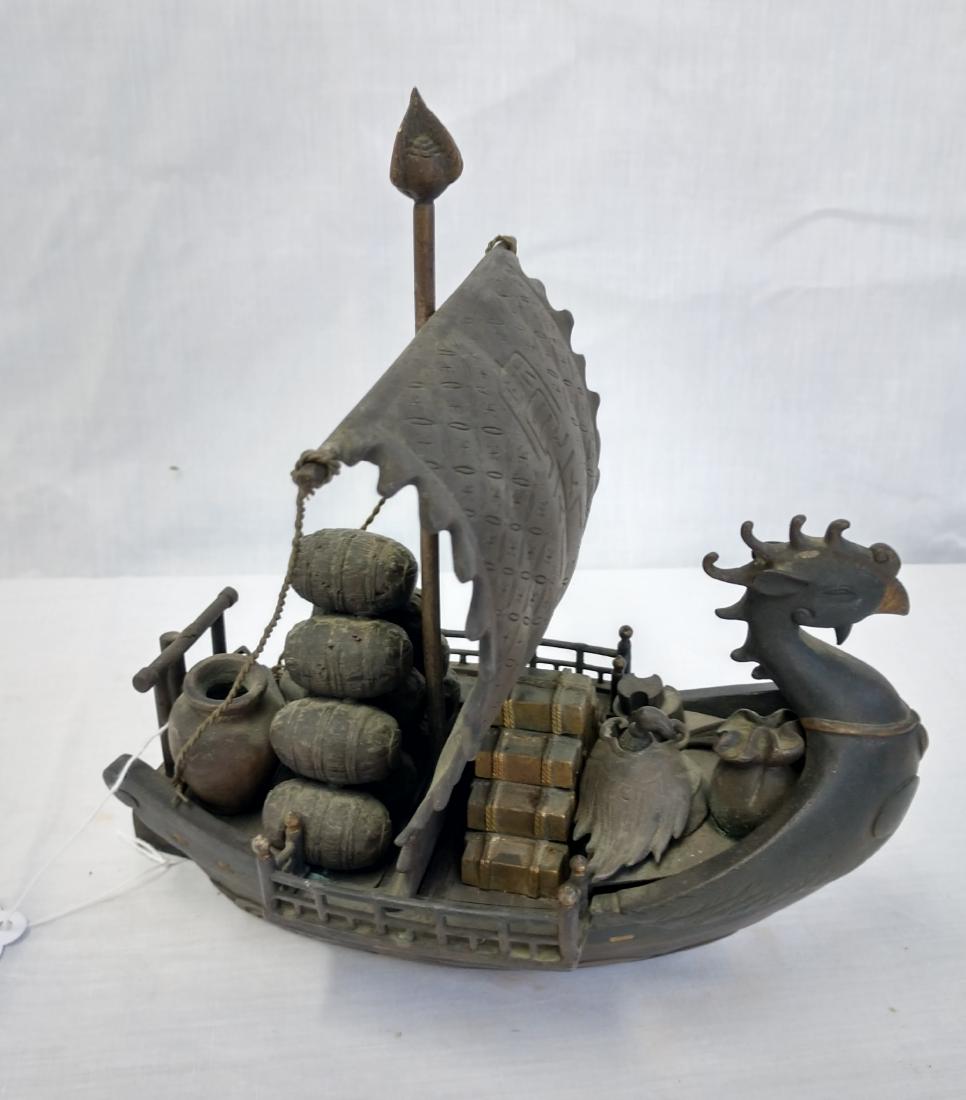 Bronze Trade Boat: Bronze Trade Boat, c. 100 years old. Made of bronze, the item measures 9" x 8" x 6". China. Effigy on front, appears to be carrying gold and wine. Condition: Good, see images. Shipping: $40.00 USA est