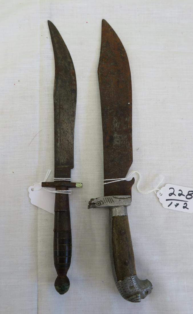 2 Antique Mexican Bowie Knives: 2 Antique Mexican Bowie Knives, c. 1900. Made of horn and steel, the items measure 12 1/2" x 1 1/2" and 12" x 1 1/8". Central Mexico. Message on one blade, both decorated, one appears to be signed by 