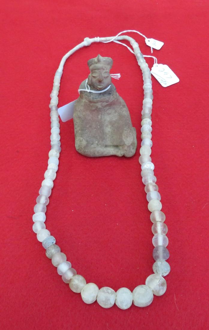 Pre-Columbian Necklace & Figure: Pre-Columbian Necklace & Figure, pre-Columbian items. Made of clay and crystal beads, the figure measures 4 1/2" x 3 1/2". Mayan, Guatemala. Necklace is 30". Condition: Head broken and glued, see imag