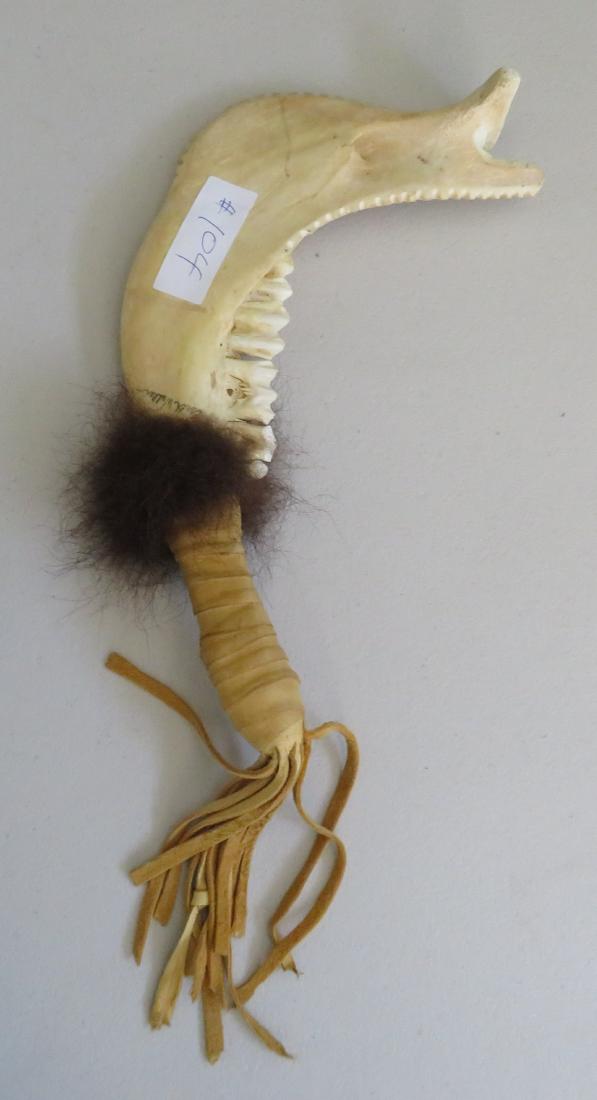 "Jawbone of an Ass" Club: "Jawbone of an Ass" Club, c. 1950s. Made of bone and leather, the item measures 14" x 6" x 2". Signed, Southwest USA. Similar weapon recorded in the Bible and used by Sampson. Condition: Good, see ima