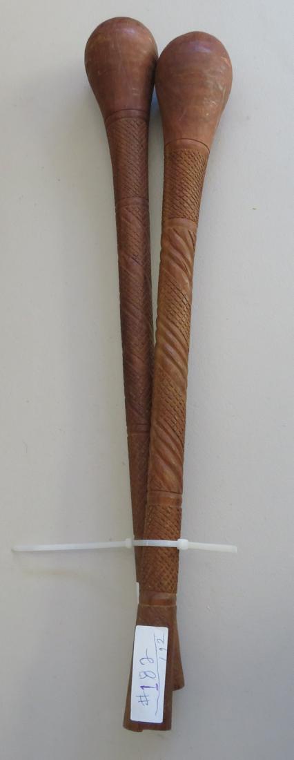 2 Polynesian Clubs: 2 Polynesian Clubs, c. 1940s. Made of hardwood, the items measure 24" x 4" each. Condition: Good, see images. Shipping: $42.50 w/insurance and signature, due to length and weight.