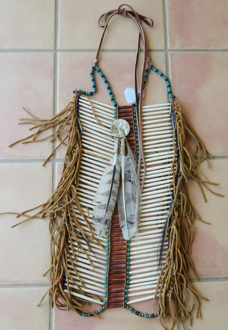 Coyote Bone Breastplate: Coyote Bone Breastplate, 20th century item. Made of bone, leather, glass, shell and feathers, the item measures 33" x 12" overall. Southwest USA. Condition: Good, see images. Shipping: $26.50 w/insura