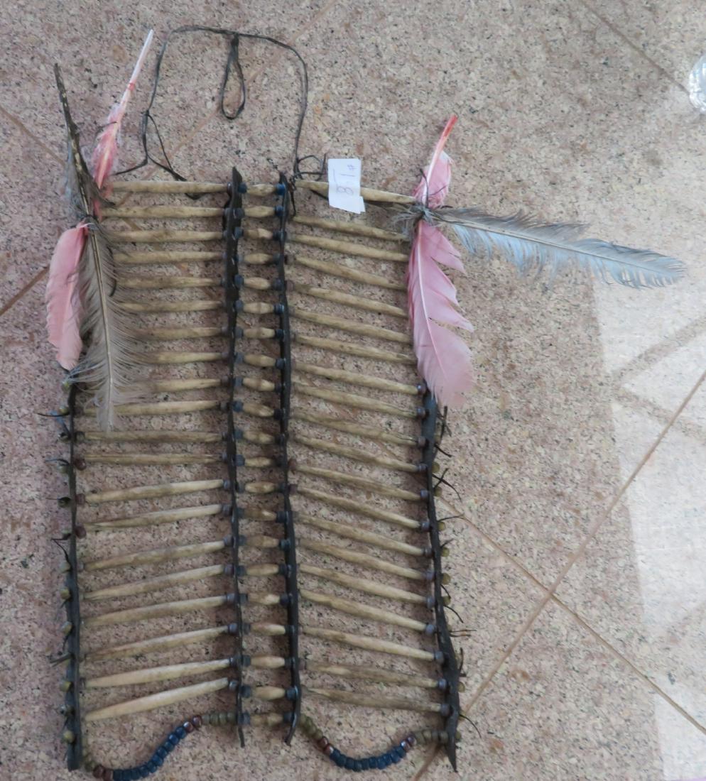 Coyote Bone Breastplate: Coyote Bone Breastplate, c. 1940s. Made of bone, leather and beads, the item measures approx. 14" x 12". Plains Indian. Condition: Wear and stains, see images. Shipping: $25.50 w/insurance and signatu