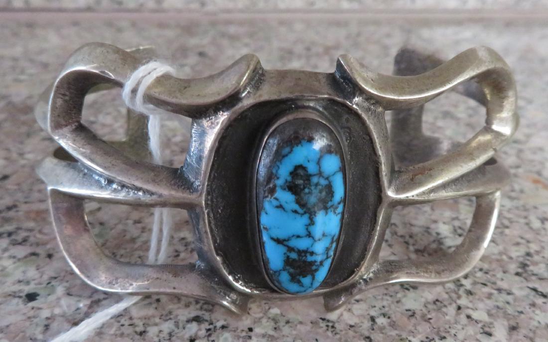 Sandcast Silver Bracelet: Sandcast Silver Bracelet, c. 1930s. Made of sterling silver and turquoise, the item measures 5 3/8" inside, 3" x 2" x 1 1/4" overall, and weighs approx. 65.7 grams. New Mexico. Condition: Good, see im