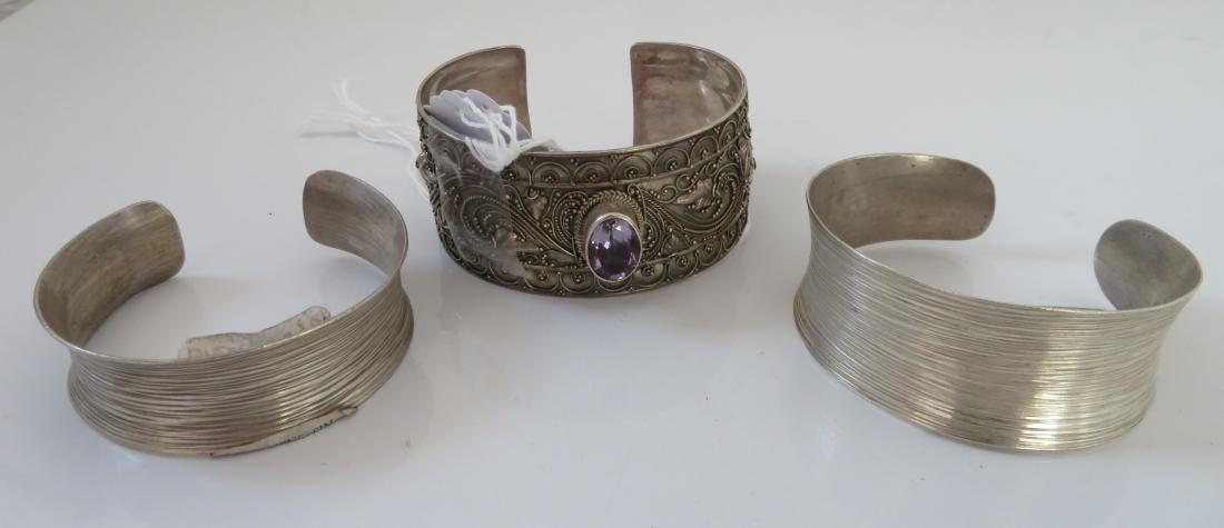 3 Handmade Cuff Bracelets: 3 Handmade Cuff Bracelets, antique items. Made of sterling silver and aquamarine, the 2 Burmese cuffs measure 7" and 6" inside with a 1" opening, other European item measures 7" with a 1" opening. Con
