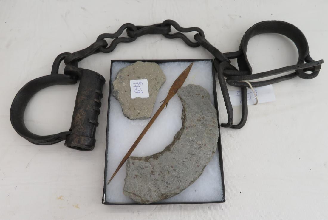 Artifacts & Leg Irons: Artifacts & Leg Irons, 500+ years old. Made of steatite, clay and iron, the leg irons measure 24" long. African artifacts. Frame included. Condition: Rust, see images. Shipping: $26.50 w/insurance and