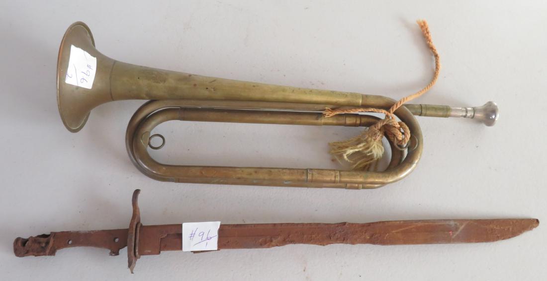 US Cavalry Trumpet & Bayonet: US Cavalry Trumpet & Bayonet, c. WWI. Made of brass and steel, the bayonet measures 19.5" long. USA. Condition: Bayonet rusty, see images. Shipping: $35.50 w/insurance and signature.