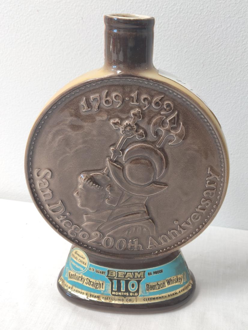 Jim Beam Bottle: Jim Beam Bottle, c. 1969. Made of glass, the item measures 10" x 7" x 2". USA. 200th San Diego Anniversary. Condition: No stopper, see images. Shipping: $23.50 w/insurance and signature, due to size a