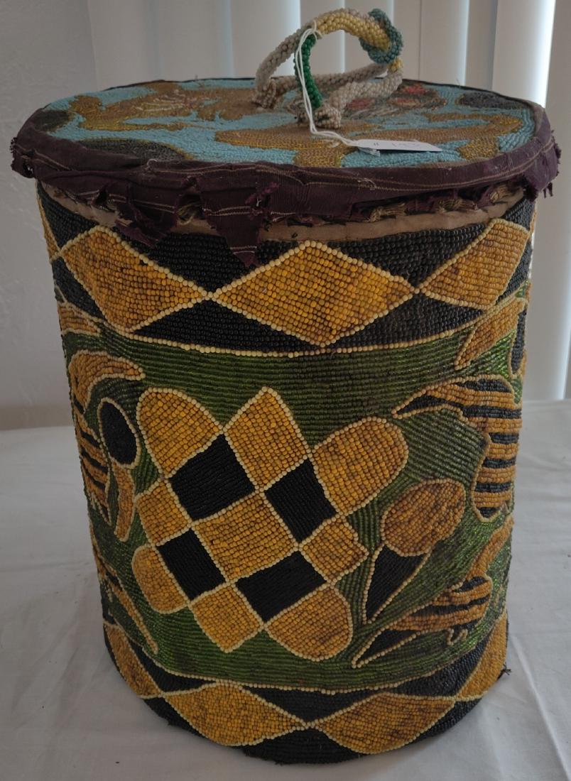 Large Beaded Cylinder: Large Beaded Cylinder, c. 1950s. Made of leather, glass beads and cloth, the item measures 14 1/2" tall x 11" wide. Nigeria, Yoruba, African. Condition: Some minor wear, see images. Shipping: $45.00 w