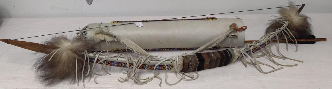 Beaded Bow, Arrow + Quiver: Beaded Bow, Arrow + Quiver, 20th century items. Made of commercial leather, seed beads, wood, synthetic sinew, feathers and hair, the bow measures 43" long, the quiver measures 21" long. The arrow mea