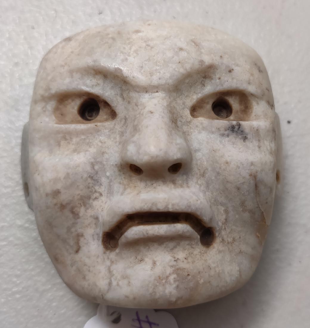 Rare Olmec White Human Maskette: Rare Olmec White Human Maskette, pre-Columbian item. Made of quartzite, the item measures 2 1/2" x 2 1/2" x 1 1/2". Rio Pesquero, Veracruz, Mexico. Helm Certificate of Authenticity available. Conditio