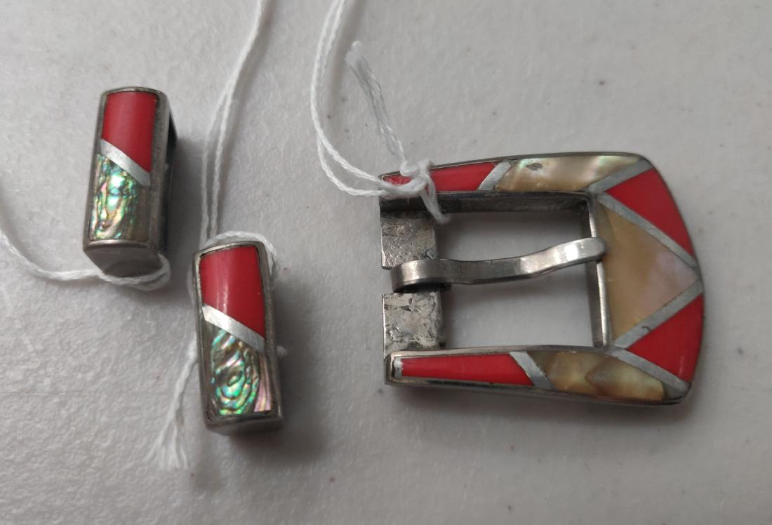 Sterling Silver & Inlaid Stone Buckle Set: Sterling Silver & Inlaid Stone Buckle Set, c. 1940s. Made of sterling silver, coral, mother of pearl and abalone, the items measure from 3/4" to 1 3/4" long, weighing approx. 33 grams. Navajo, Arizona