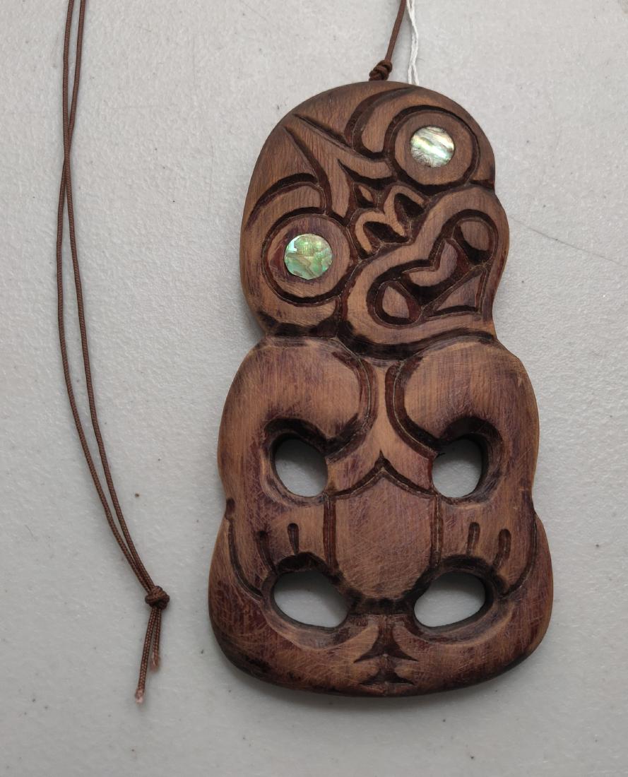 Maori Pendant: Maori Pendant, c. 1960s. Made of wood and shell, the item measures 6 1/2" x 3 5/8" x 1/2". Maori, New Zealand. Condition: Good, wear from use, see images. Shipping: $13.50 w/insurance and signature.